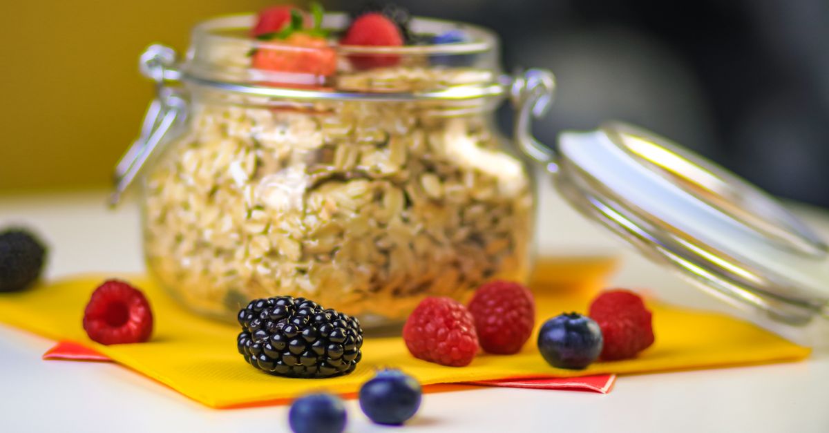 Overnight oats in a glass jar topped with fresh berries